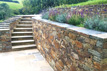 Stone-wall terracing with sand-stone paving path to sandstone steps South Devon